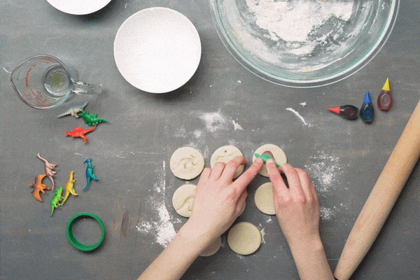 Child doing a "Make Your Own Dinosaur Fossil" craft