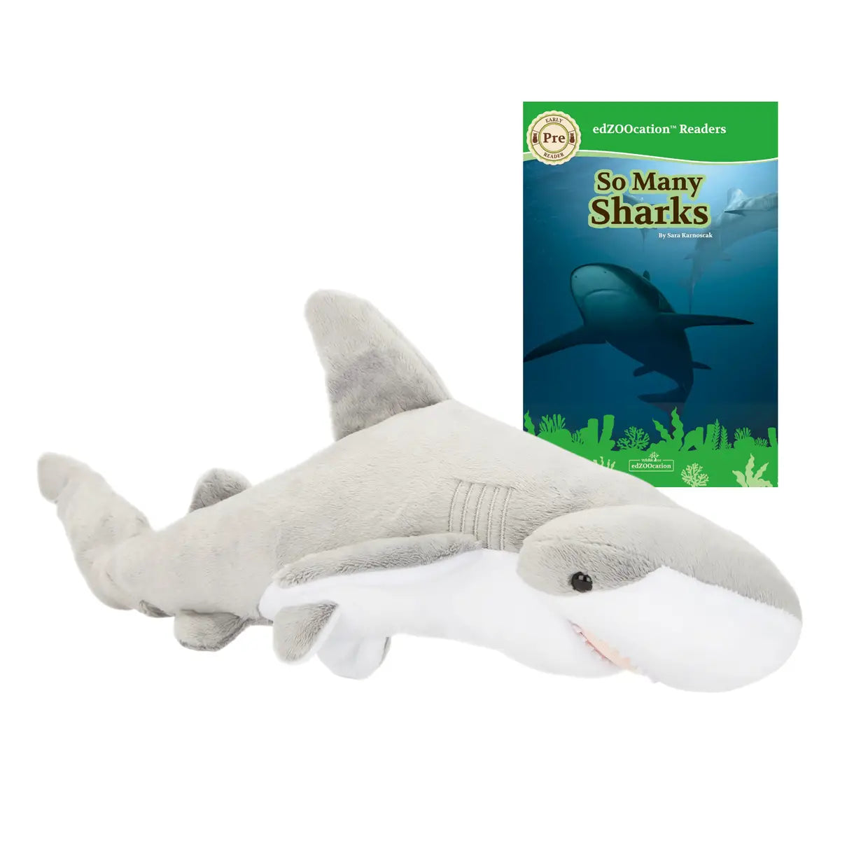 Plush shark toy next to a book titled 'So Many Sharks' on a white background