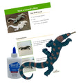 An image showing a Komodo dragon figurine along with a bottle of white school glue, presumably for crafting or educational purposes.