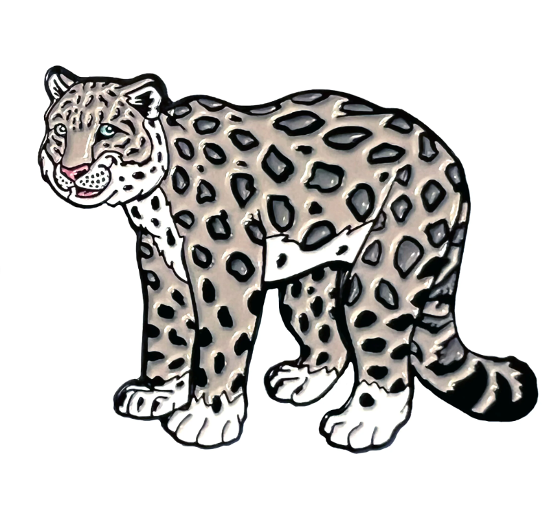 Photo of enamel pin of a Snow Leopard