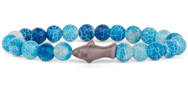 Bracelet with blue and gray beads and a fish-shaped charm on a white background