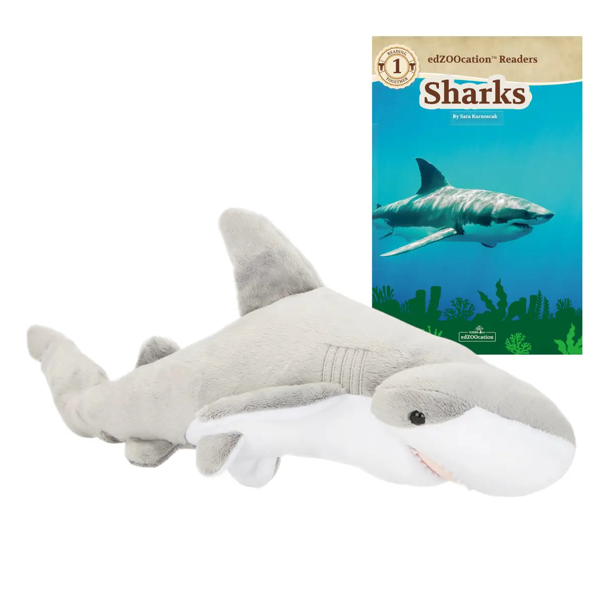 Plush shark toy next to a book titled 'Sharks' on a white background
