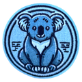 Blue embroidered patch of a koala bear with a tree on a white background
