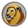 Embroidered patch of a lion's head with a circular border on a white background