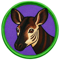 Embroidered patch of a zebra's head on a purple background with a green border