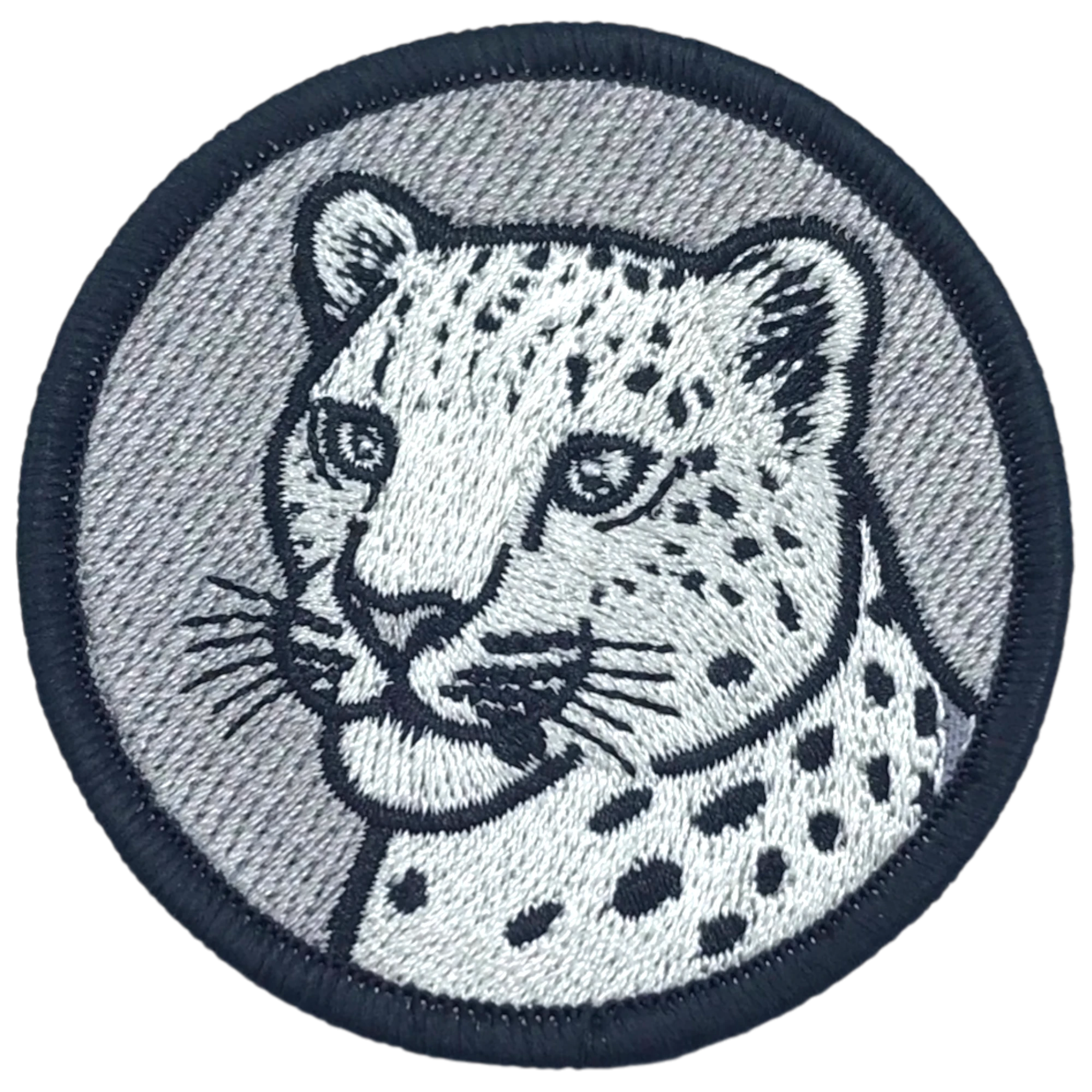 Embroidered patch of a leopard's head on a gray background