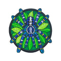 Embroidered peacock tarantula patch, a blue spider on green leaves