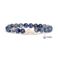 Blue marbled bead bracelet with a dolphin charm on a white background