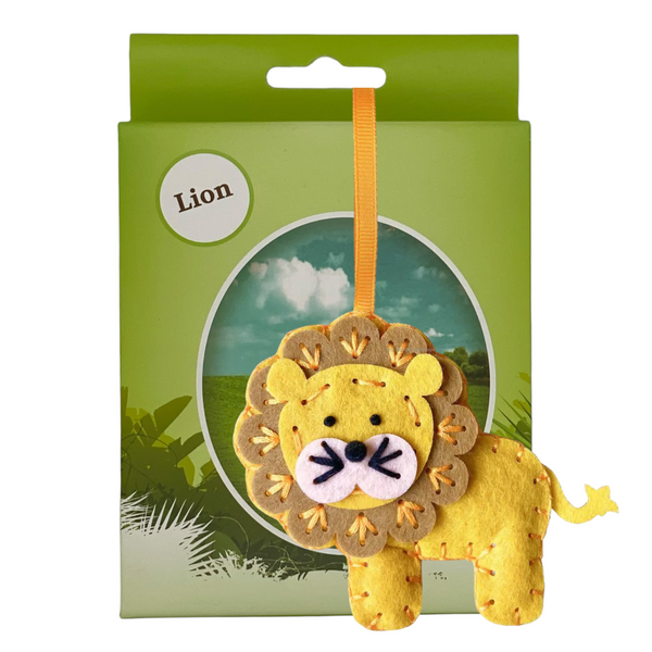 A lion sewing kit packaged in a box with a lion plushie displayed in front, predominantly yellow with black and orange details.